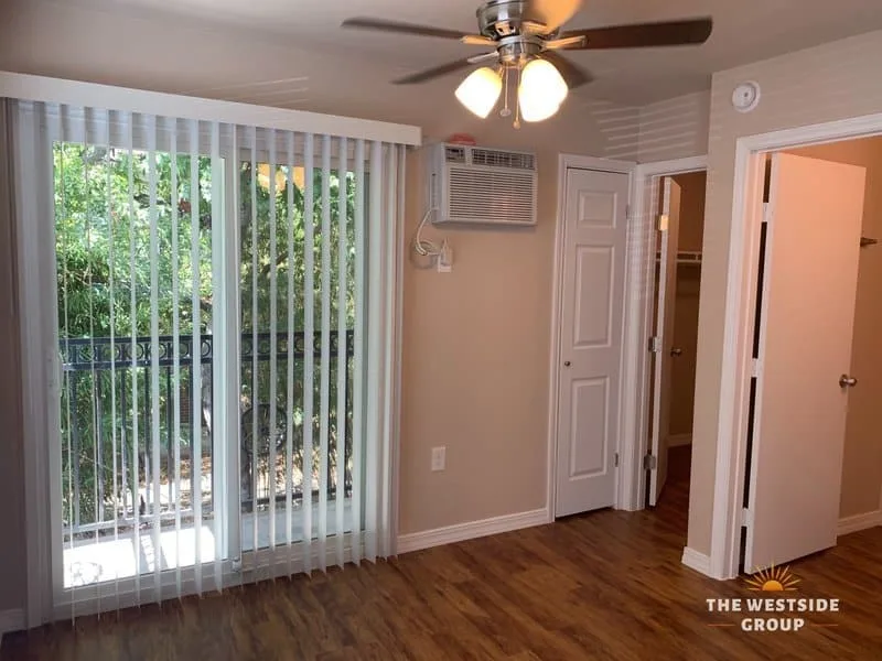 sliding glass door with blinds on austin studio apartment